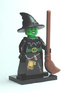 Toy figure of a witch with a broom on a white background