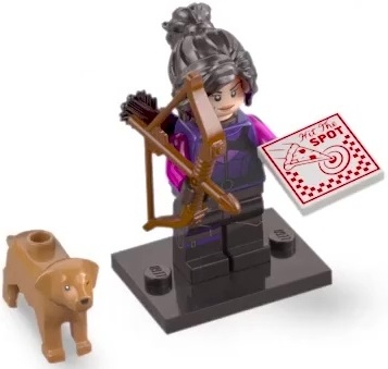 A toy minifigure with dark hair, a purple outfit, and a brown bow and arrow, displayed on a black base with a small brown dog figure and a red-and-white card labeled 'Just The Spot' on a white background.
