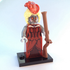 Toy figure with a red dress, white wig, and holding a rifle on a white background
