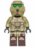 Toy figure in a desert camouflage outfit with green goggles on a white background